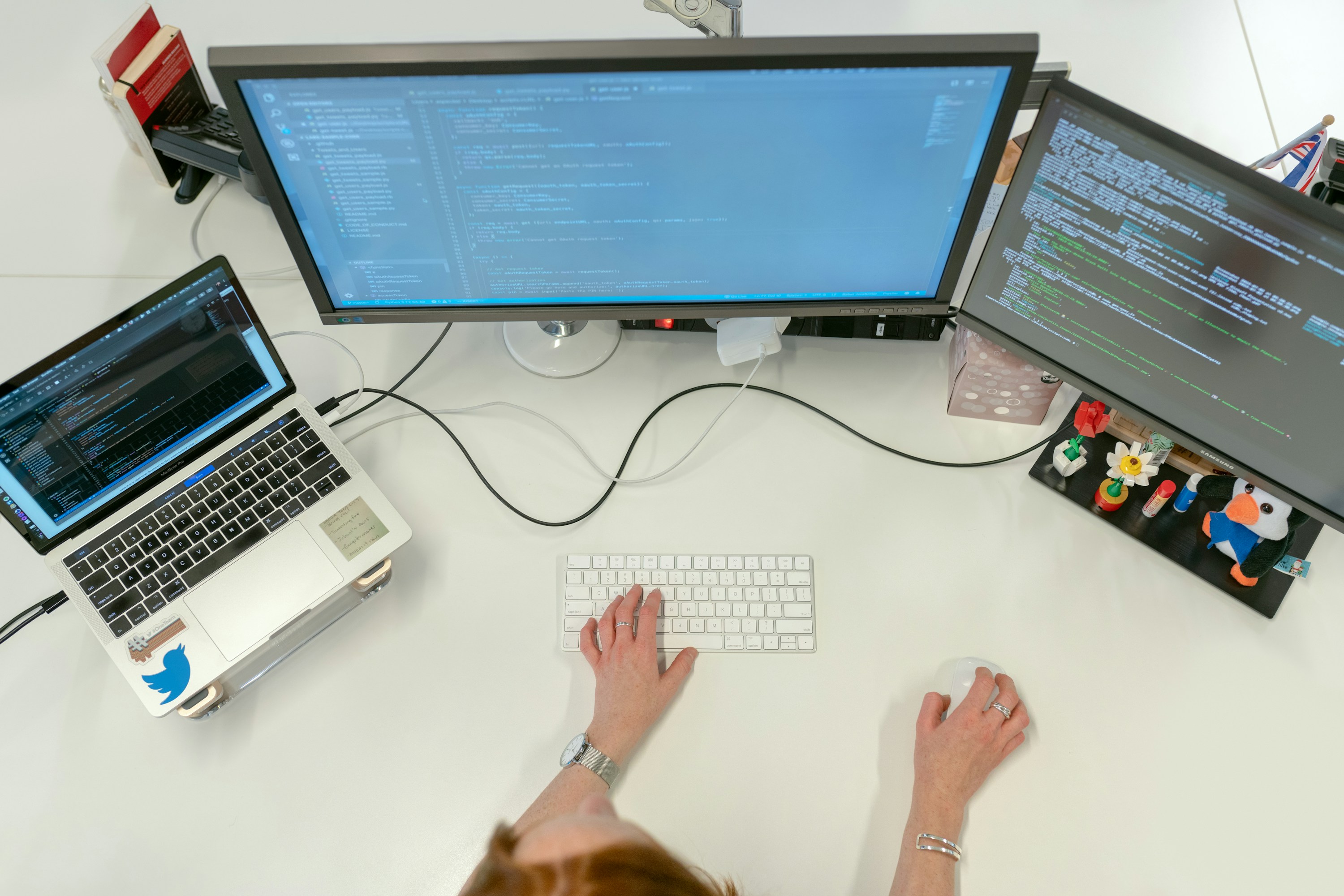 A close view of software development work across multiple screens